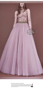Detailed view of shimmering rhinestone waist belt on a purple mesh evening gown