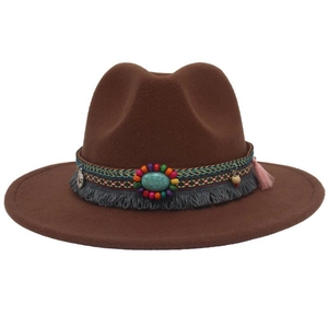 Detail of brown wool felt cowboy hat with turquoise stone and ethnic beaded band trim