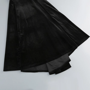Close-up of black velvet fishtail dress hem showing high-quality fabric texture