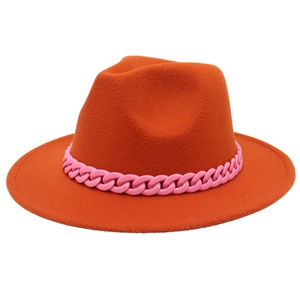 Detail of orange wool fedora featuring a wide brim and chunky pink acrylic chain decor