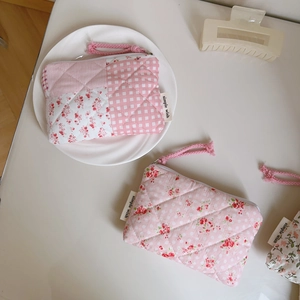 Detailed shot of pink floral quilted cotton coin purse with zipper and simple wish label
