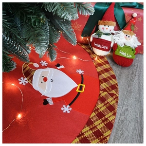 Detailed applique of Santa Claus on red felt Christmas tree skirt with festive textures