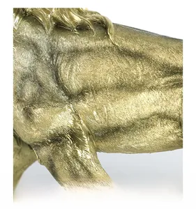 Macro view showing the detailed lifelike hair textures of the golden lion resin sculpture
