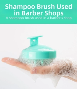 Detail of mint green scalp massager brush creating rich white foam in palm of hand