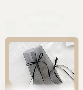 Detail of sheer black socks with bows and soft elastic cuffs for a comfortable fit