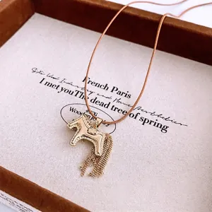 Retro golden pony pendant necklace with chain tassels on a brown leather cord