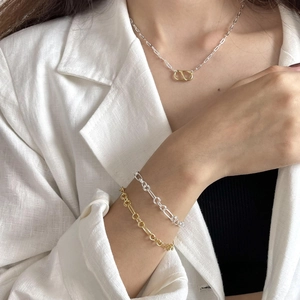 Detail of minimalist 925 sterling silver O-ring chain bracelets with interlocking rings