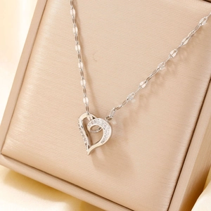 Elegant silver hollow heart pendant necklace with zircons displayed in a gift box