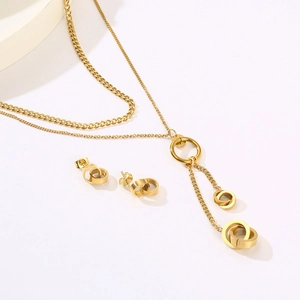 Detailed view of 18K gold plated double layer necklace and interlocking ring earrings
