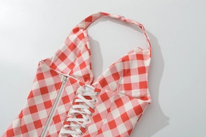 Detail of red and white plaid halter top with rope ties and silver zipper closure