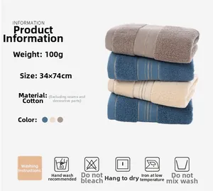 Close-up of three stacked pure cotton towels in blue, beige, and grey colors