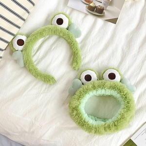 Detail showing soft green plush frog headband and hairband for washing face