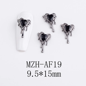 Detail of gothic dark heart nail charms with liquid metal drip frame and black gemstone