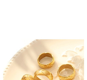 Close-up of four gold quilted geometric rings with elegant polished finish