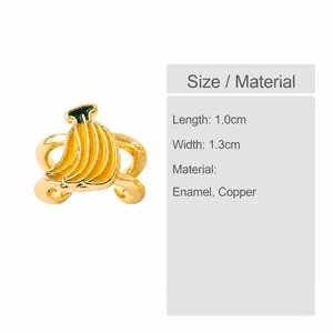 Close-up of a 1.0cm x 1.3cm yellow enamel banana ear cuff with gold plated copper details