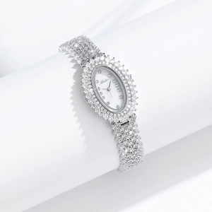 Detailed close-up of a silver oval luxury watch with sparkling zircon and chain strap