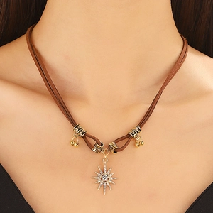 Brown leather double-layer choker with gold starburst pendant and bohemian bead accents