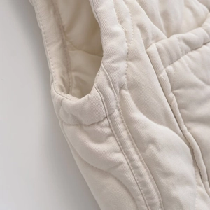 Beige quilted loose-fit high-neck vest with drawstring hem and textured stitching detail