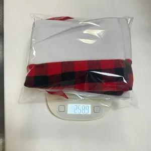 Weight measurement of six large red and black plaid plush Christmas stockings in packaging