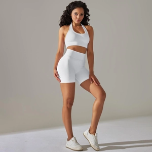 Close-up of white seamless yoga set with ribbed waistband and halter neck sports bra