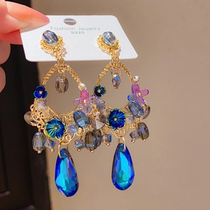 Detail of vintage teardrop earrings with S925 silver needles and colorful crystals