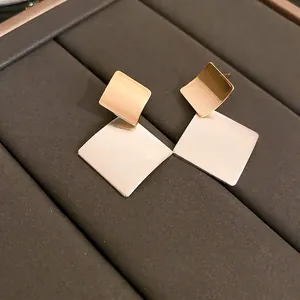 Brushed geometric rhombus stud earrings in gold and silver finish for a modern luxury look