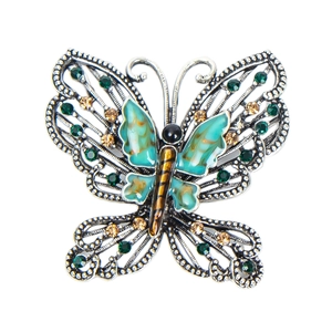 Vintage silver butterfly brooch with emerald green enamel and crystals on white base