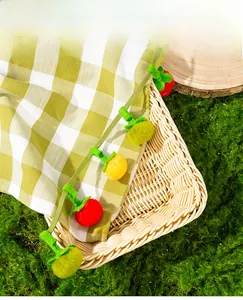 Close-up of catnip cat toy with colorful handmade felt fruit charms and a small bell