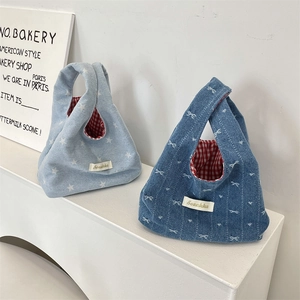 Cute denim wrist bags with star and bow patterns featuring red checkered lining