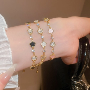 Detailed view of elegant acetate flower bracelets with zircon inlay in three colors