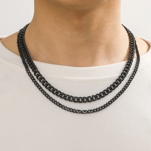Close-up of black double-layered stainless steel curb chain necklace on a model