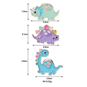 Detailed view of three colorful cartoon dinosaur enamel pins with sizes and total weight