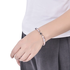 Detail of beaded projection bracelet with 6mm marble beads worn on a wrist