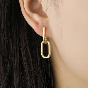 Minimalist gold S925 sterling silver geometric oval hoop earrings worn on a female model
