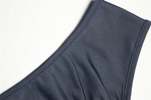 Detailed macro view of high-quality smooth fabric with precise stitching and silky finish