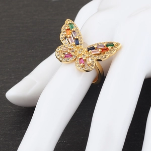 Macro shot of gold butterfly ring featuring colorful crystals and micro-set zircon stones