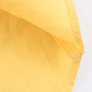 Women loose yellow shirt with curved hem and classic lapel made of premium polyester