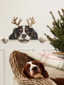 Detail of Christmas dog wall sticker with golden reindeer antlers on a white wall