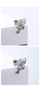 Macro shot of butterfly key titanium steel studs with colorful zircon stones on stone blocks