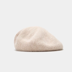Detail of beige sequined beret hat showing knitted rabbit fur texture and sparkling finish