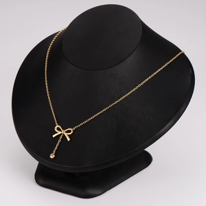 Elegant gold bow necklace with tassel crystal on black neck model for women