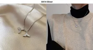 Detail of 925 silver whale tail necklace with sparkling pavé and mother of pearl inlay