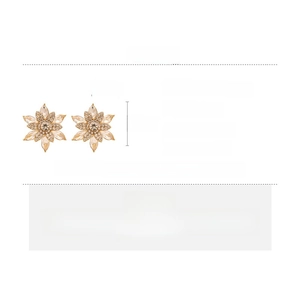 Detailed view of luxury gold snowflake earrings with rhinestone pavé and size dimensions