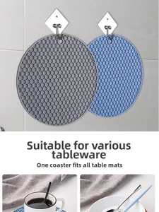 Detail of round honeycomb silicone placemats in grey and blue with hanging hole design