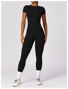 Detail view of black compression yoga set featuring a short sleeve top and high waist leggings