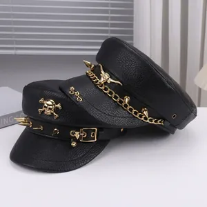 Close-up of black PU leather baker boy hats with punk skull and rivet metal details