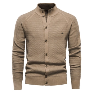 Detailed view of the textured knit pattern and dark buttons on this men's cardigan