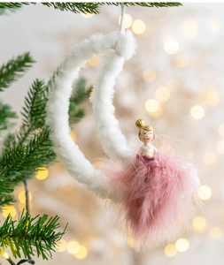 Detail of plush white moon and pink feather fairy ornament hanging on a Christmas tree
