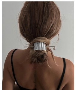 Silver wavy hairpin with pearl pendant shown in hair bun for modern styling