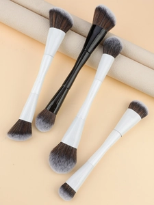 Detail of dual-ended makeup brushes with synthetic bristles for blush and contouring